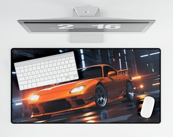 May include: Orange sports car with black accents and a white keyboard on a black and gray gaming mouse pad.