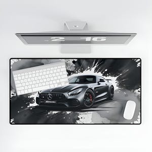 May include: A black and white mousepad with a black sports car and white paint splatters. The car is a Mercedes-Benz AMG GT with the AMG logo on the front. The mousepad also has a white keyboard and a white mouse.