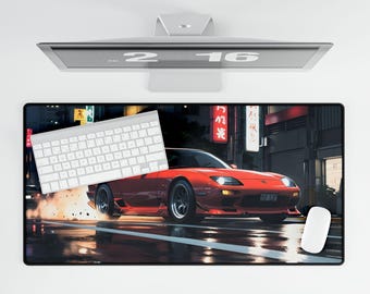 May include: A red sports car with black wheels and a black keyboard on a black and white mouse pad with a city street scene in the background.