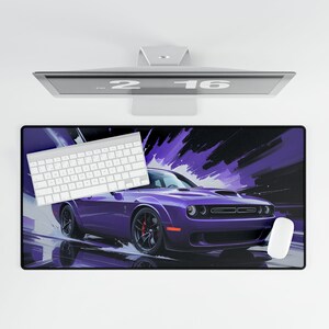 May include: A purple sports car mousepad with a white keyboard and mouse. The mousepad features a stylized image of a purple car with black wheels and red brake calipers. The background has purple and black brushstrokes.