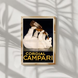 Pu&ograve; includere: Una pubblicit&agrave; vintage incorniciata per Cordial Campari. L'opera presenta un orso polare bianco che beve da una bottiglia di Campari. Il testo "Cordial Campari" &egrave; in lettere dorate.