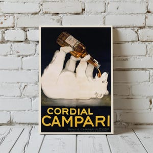 Pu&ograve; includere: Poster pubblicitario vintage con un orso polare che versa Campari da una bottiglia. La scritta "Cordial Campari" &egrave; gialla su sfondo scuro. Il poster incorniciato &egrave; appeso a un muro di mattoni bianchi.