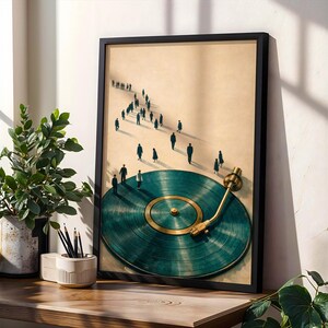 May include: A framed art print featuring a teal vinyl record with a gold tone center and arm. Silhouetted figures walk towards the record. The artwork is displayed on a wooden surface with a potted plant and a pencil holder.