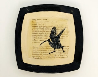 Sgraffito carved Curlew on a ceramic art platter with bird definitions with an antique parchment look.