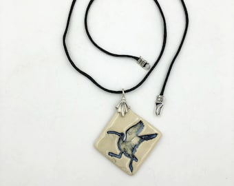 Ceramic curlew pendant on a satin ratail cord with sterling silver bail