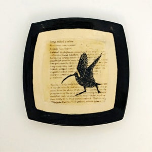 Sgraffito carved Curlew on a ceramic art platter with bird definitions with an antique parchment look.