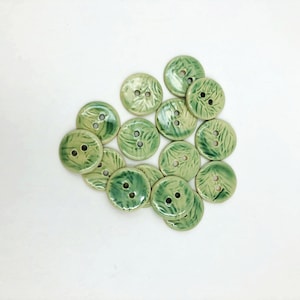 Set of 3 handmade ceramic buttons in off-white stoneware, with soft green glaze and random leaf texture