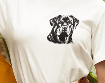 May include: White t-shirt featuring a black and white graphic of a Rottweiler dog's face. The dog's portrait is centered on the chest of the shirt. The shirt has a crew neck and short sleeves.
