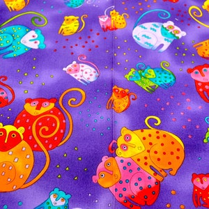 May include: A vibrant purple fabric featuring a repeating pattern of colorful, cartoonish monkeys. The monkeys are in various colors, including red, orange, yellow, blue, and pink, with whimsical details and dot patterns. The fabric is suitable for various craft projects.