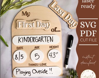 May include: A wooden sign with the text "My First Day of Kindergarten" and spaces to fill in the date, age, and height. The sign also includes the text "Things I Love" and a space to write in what the child loves. The sign is decorated with a white arch and the text "Last Day" in a brown font.