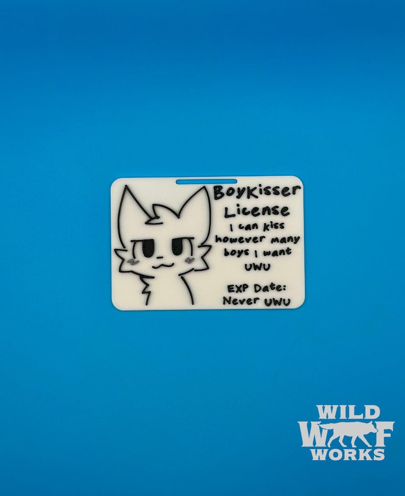 The Boykisser License charm displayed on a solid blue background, with the "WILD WOLF WORKS" logo in the bottom right corner.