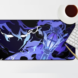 May include: A rectangular mouse mat with a design of a lantern and blue and purple flames on a dark background. A white keyboard, a cup of coffee, and a gold pen are also visible.