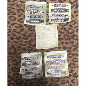 May include: Vintage Wrigley's Juicy Fruit chewing gum wrappers and a United Profit Sharing coupon. The wrappers are green and white with the brand name in a bold, purple font. The coupon is pale green.