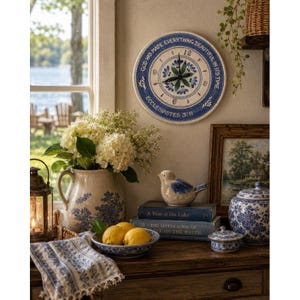 May include: A decorative wall clock with the text "GOD HAS MADE EVERYTHING BEAUTIFUL IN ITS TIME" and "ECCLESIASTES 3:11". The clock is surrounded by other decorative items, including a vase of flowers, a ceramic bird, and books.