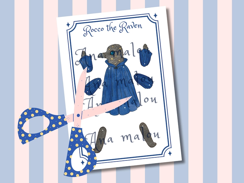 May include: A paper cutout featuring a watercolor illustration of "Rocco the Raven" with a blue cape and accessories. The image is on a white background with a blue border, and is cut with a pair of blue and yellow polka dot scissors.