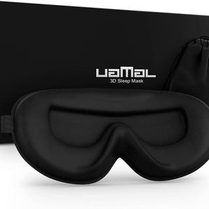 May include: A black 3D sleep mask with a contoured design to block out light. The mask is packaged in a black box with the brand name "UaMal" and the text "3D Sleep Mask".
