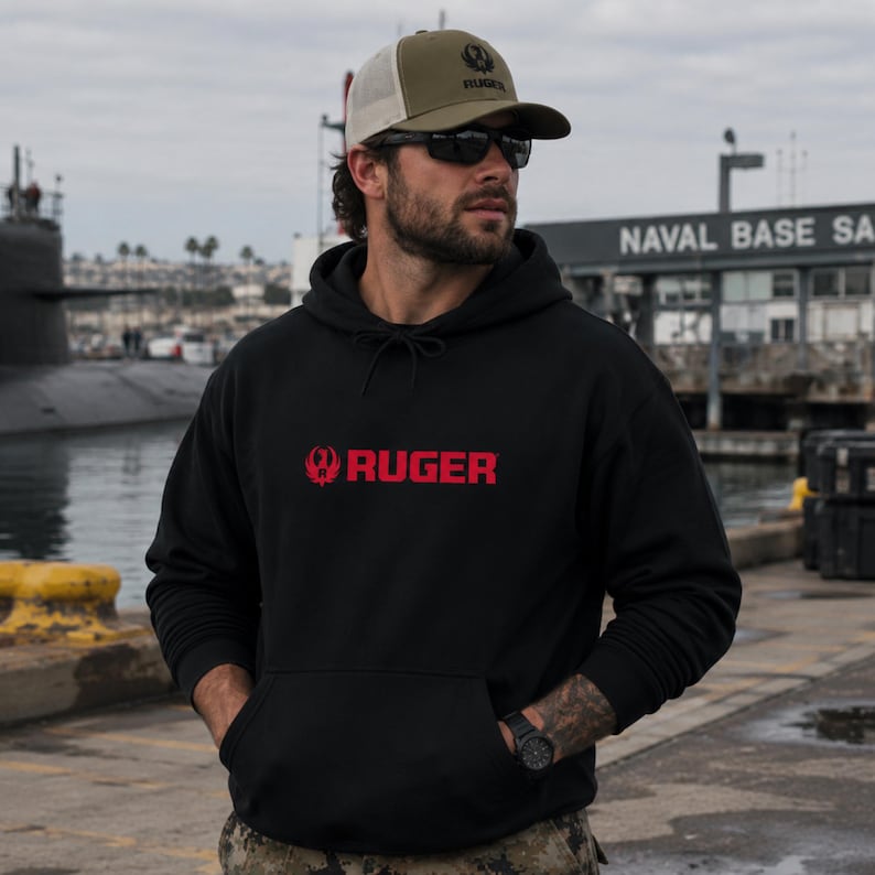 Stay mission‑ready in this Ruger logo hoodie, featuring bold red branding and durable fleece comfort. Ideal for range days, outdoor training, or casual wear. Pairs perfectly with tactical pants, jeans, or boots. A must‑have for gun owners, military supporters, and outdoor enthusiasts who value rugged style and 2A pride.