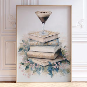 May include: A painting depicting a stack of old books with a coffee cocktail perched on top. The books have a vintage feel and the cocktail is in a martini glass with a brown and white layered appearance. The background is a white wall with decorative molding.