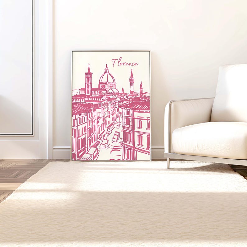 Puede incluir: Una impresi&oacute;n enmarcada con un boceto rosa de Florencia, Italia. La obra de arte representa edificios, calles y monumentos, incluyendo una c&uacute;pula y una torre prominentes. La palabra "Florence" est&aacute; escrita en cursiva en la parte superior.