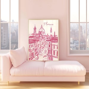 Puede incluir: Una impresi&oacute;n enmarcada de Florencia, Italia, en un estilo de boceto rosa y blanco. La obra de arte representa la arquitectura de la ciudad, incluido el Duomo. La impresi&oacute;n se exhibe en un chaise longue rosa en una habitaci&oacute;n con grandes ventanas.