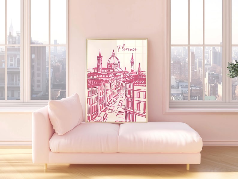 Puede incluir: Una impresi&oacute;n enmarcada de Florencia, Italia, en un estilo de boceto rosa y blanco. La obra de arte representa la arquitectura de la ciudad, incluido el Duomo. La impresi&oacute;n se exhibe en un chaise longue rosa en una habitaci&oacute;n con grandes ventanas.