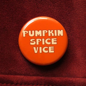 May include: Orange button with the text "Pumpkin Spice Vice" in white.