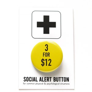 Round yellow pinback button that reads 3 for $12 in black. The button is on a SOCIAL ALERT BUTTON backing card.