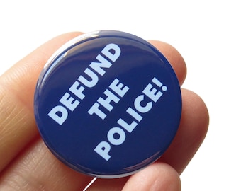 May include: A blue button with white text that reads "DEFUND THE POLICE!"