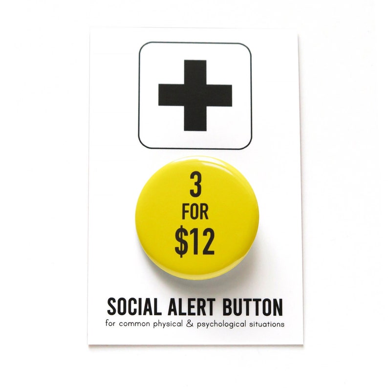 Round yellow pinback button that reads 3 for $12 in black. The button is on a SOCIAL ALERT BUTTON backing card.