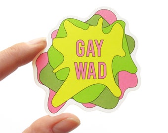 Puede incluir: Una pegatina amarilla, verde y rosa con el texto "GAY WAD" en letras rosas.