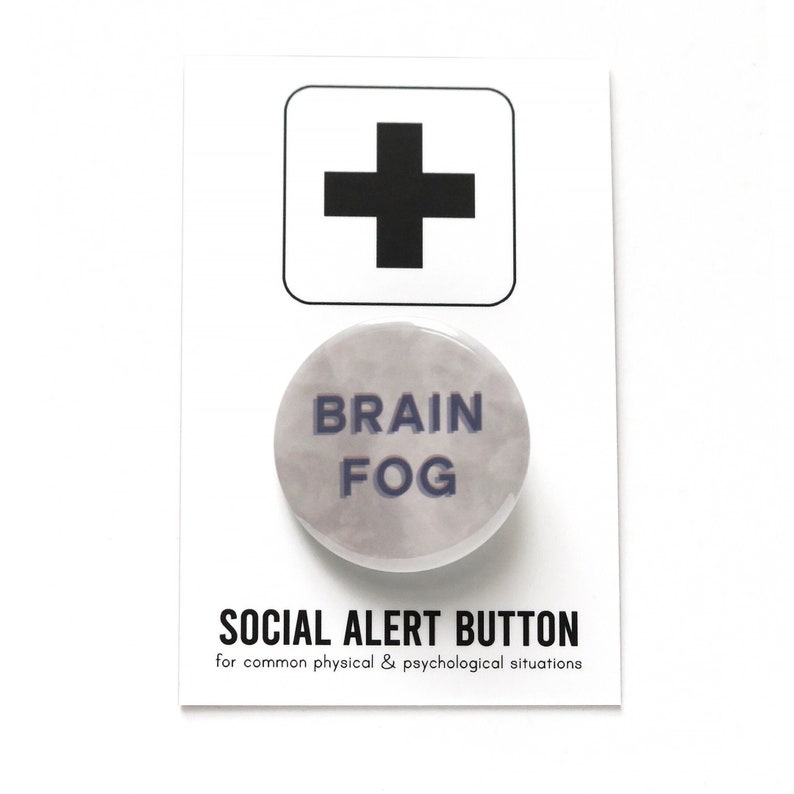 Round foggy gray & white marbled background pinback button that reads BRAIN FOG in muted blue. The button is on a SOCIAL ALERT BUTTON backing card.
