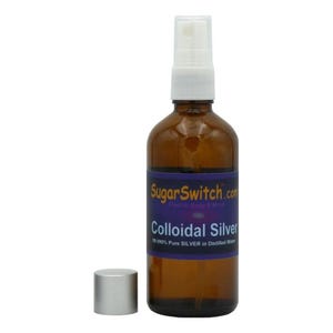May include: A brown glass spray bottle with a white spray nozzle and a silver cap. The bottle has a label with the text "SugarSwitch.com" and "Colloidal Silver". The label also states "99.999% Pure SILVER in Distilled Water".