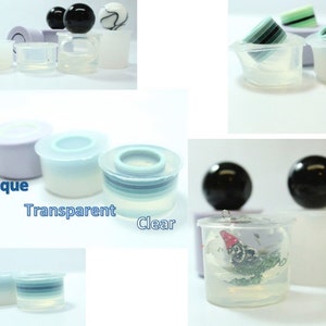 May include: A set of silicone moulds for making resin crafts. The moulds are available in opaque, transparent, and clear finishes. The moulds are shown with various resin creations, including spheres, rings, and a small figurine.