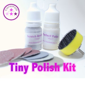 May include: A small kit for polishing resin jewellery. It includes two bottles, one labelled "Scratch Remover" and the other labelled "Perfect Polish". The kit also includes a small sanding block, four sanding pads, and a buffing wheel.