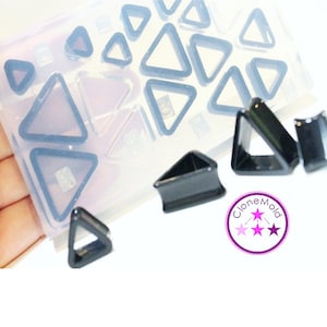 May include: A clear silicone mold with multiple triangle shapes, used for making jewelry.  The mold is filled with black triangle-shaped plugs.  The text "Clone Mold" is visible in the image.