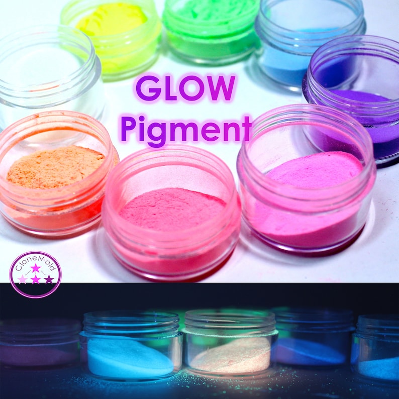 May include: A collection of small jars filled with glow-in-the-dark pigment powder. The jars are arranged in a circle, with the text "GLOW Pigment" in the center. The jars are filled with different colors of powder, including pink, orange, green, blue, and purple. The bottom of the image shows the jars glowing in the dark.