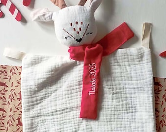 A Christmas dou-dou in the shape of a deer made of cotton muslin. A personalized Christmas gift idea for newborns with embroidered names.