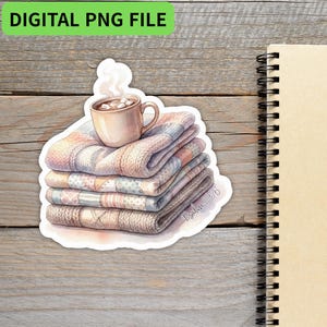 May include: A sticker featuring a stack of cozy blankets in pastel colors, topped with a mug of hot chocolate with marshmallows. The sticker has the text "DIGITAL PNG FILE" and "Psalm 119:76".