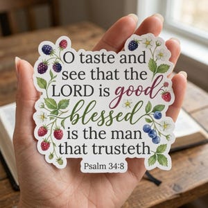 May include: A die-cut sticker featuring the text O taste and see that the LORD is good blessed is the man that trusteth Psalm 34:8. The design is decorated with watercolor illustrations of blackberries, raspberries, blueberries, and white flowers.