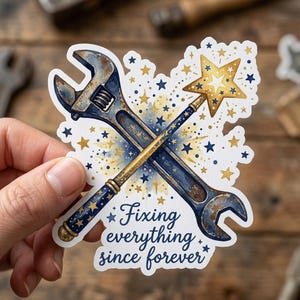 May include: A die-cut sticker featuring a crossed adjustable wrench and a star-topped wand. The wrench has a weathered blue finish, while the wand is dark blue with gold stars. The text reads, Fixing everything since forever, in blue script.