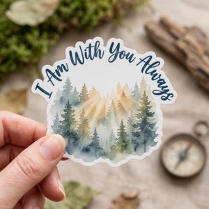 May include: A die-cut sticker featuring a watercolor illustration of a forest with sunlight shining through the trees. The sticker has the text "I Am With You Always" in a dark blue script.