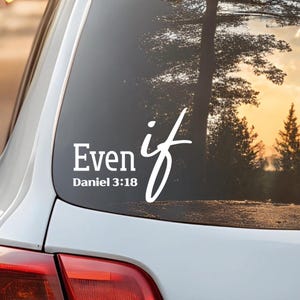 May include: White vinyl decal applied to a car window. The decal features the words "Even if" in a stylized font, with "Daniel 3:18" below. The background shows a blurred outdoor scene with trees and a sunset.