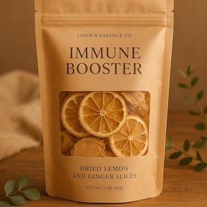 May include: A kraft paper bag labeled "IMMUNE BOOSTER" with a clear window displaying dried lemon and ginger slices. The bag also reads "DRIED LEMON AND GINGER SLICES" and "NET WT 3 OZ (85g)". The product is from "LOOM & ESSENCE CO".