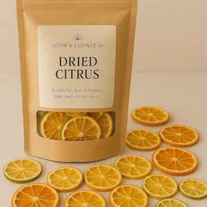 May include: A kraft paper bag labeled "LOOM & ESSENCE CO" with "DRIED CITRUS" and a description of lemon, lime, and orange slices. The bag has a clear window showing dried citrus slices, with more slices scattered around.