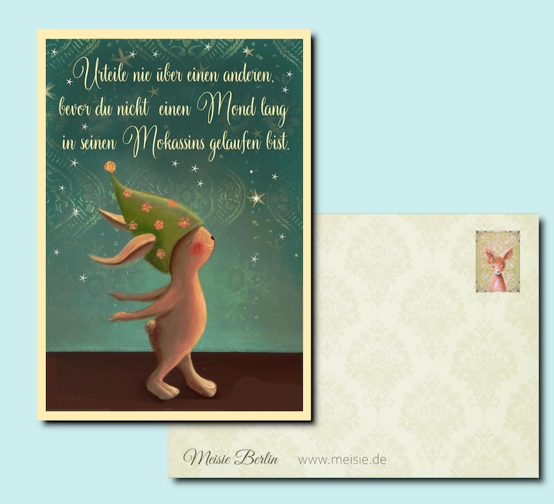 May include: A green and brown illustrated postcard with a rabbit wearing a green hat with pink flowers. The postcard has a quote in German: "Urteile nie &uuml;ber einen anderen. bevor du nicht einen Mond lang in seinen Mokassins gelaufen bist." The postcard also has the text "Meisie Berlin www.meisie.de".