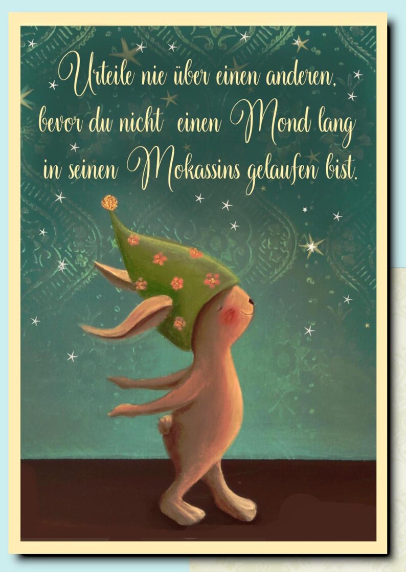 May include: A whimsical illustration of a bunny wearing a green hat with flowers, standing on a teal background with white stars. The quote "Urteile nie &uuml;ber einen anderen. bevor du nicht einen Mond lang in seinen Mokassins gelaufen bist." is written in cursive script.