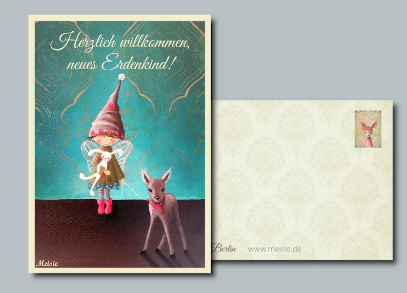 K&ouml;nnte beinhalten: Eine Gru&szlig;karte mit einer Illustration einer Fee, die ein Kaninchen und ein Reh mit einer rosa Schleife h&auml;lt. Die Karte tr&auml;gt den Text "Herzlich willkommen, neues Erdenkind!" und einen passenden Umschlag.