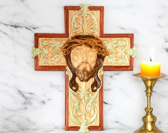 Carved wooden cross with the face of Jesus Christ
