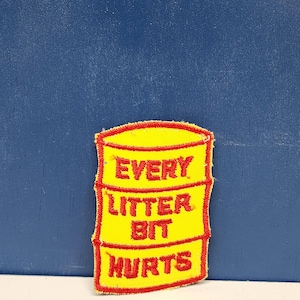May include: A yellow patch with red trim and text that reads "EVERY LITTER BIT HURTS" in red block letters. The patch is rectangular with rounded corners and is against a blue background.