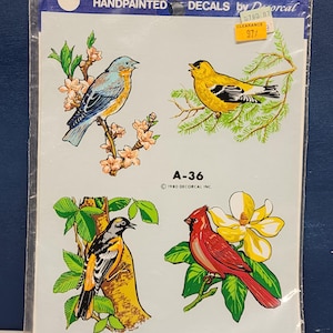 May include: A sheet of hand-painted decals featuring four colorful birds and a magnolia flower. The decals are labeled "A-36" and "1980 Decorcal, Inc."